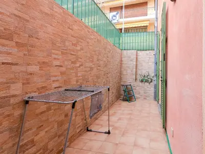 a table in a room with a brick wall at Le Marie Jeanne 6 Pers Giardino Vista Mare in Villefranche-sur-Mer