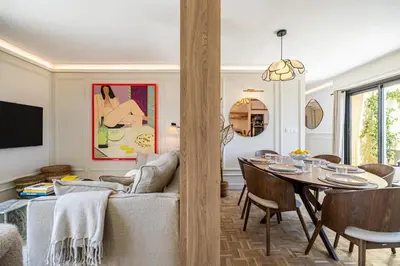 a living room with a table and a couch at Luxurious penthouse, 2 bedroom suites, 3 spacious terraces, gorgeous views of mountains and sea, in Nice