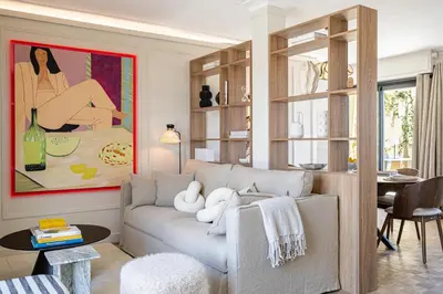 a living room with a couch and a table at Luxurious penthouse, 2 bedroom suites, 3 spacious terraces, gorgeous views of mountains and sea, in Nice