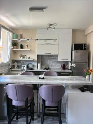 a kitchen with a counter and some purple bar stools at Elegant Apartment Terrace Port of Nice in Nice