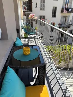 a balcony with a table and chairs on a balcony at Elegant Apartment Terrace Port of Nice in Nice