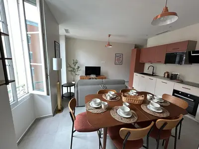 a kitchen and dining room with a table and chairs at Charming accommodation in Port de Nice in Nice