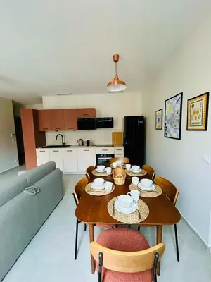 a living room with a table and a couch at Charming accommodation in Port de Nice in Nice