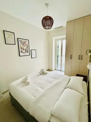 a bedroom with a large white bed with towels on it at Charming accommodation in Port de Nice in Nice
