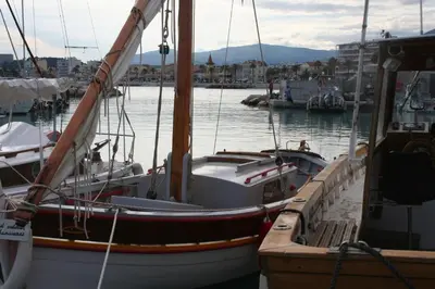 a boat is docked at a dock in the water at Rez de jardin en bord de mer in Cagnes-sur-Mer