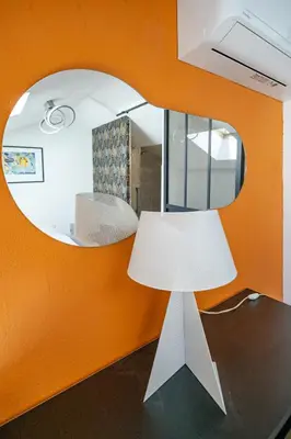 a white lamp in front of a mirror at Duplex 4 pers Port de Nice avec parking in Nice