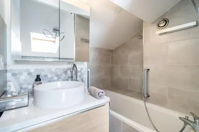 a bathroom with a white sink and a shower at Duplex 4 pers Port de Nice avec parking in Nice