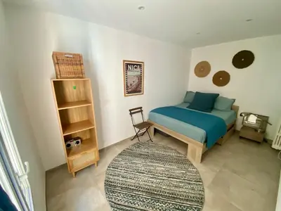 a bedroom with a blue bed and a rug at Au cœur du Vieux Nice, 3 chambres au calme, grand appartement in Nice