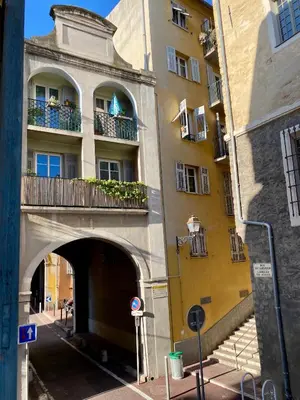 a building with an archway and a building with windows at Au cœur du Vieux Nice, 3 chambres au calme, grand appartement in Nice