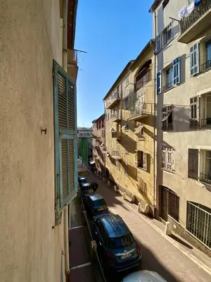 a row of cars parked on a street next to buildings at Au cœur du Vieux Nice, 3 chambres au calme, grand appartement in Nice