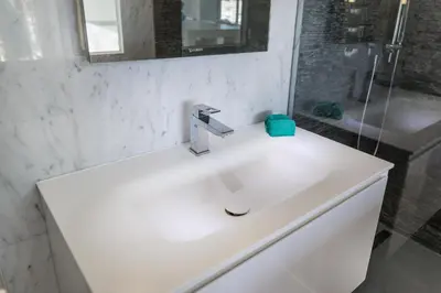 a bathroom with a white sink and a shower at 3P ST Jean in Saint-Jean-Cap-Ferrat