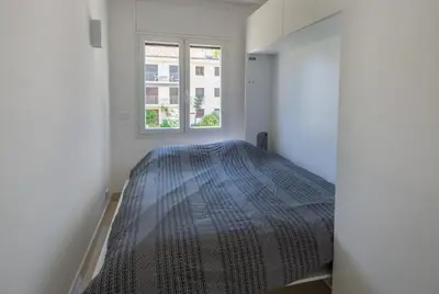 a bedroom with a bed and a window at 3P ST Jean in Saint-Jean-Cap-Ferrat