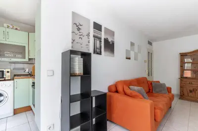 a living room with an orange couch in a kitchen at HAPPYFEW Le Palais des Arts in Nice