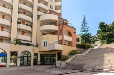 an apartment building with stairs in front of it at HAPPYFEW Le Palais des Arts in Nice