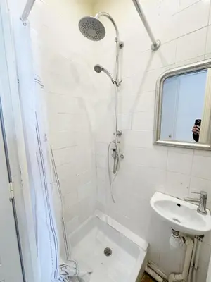a white bathroom with a shower and a sink at Cosy appartement gare du sud - Nice - 3 guests in Nice