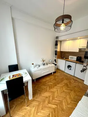 a kitchen with a table and a sink in a room at Cosy appartement gare du sud - Nice - 3 guests in Nice