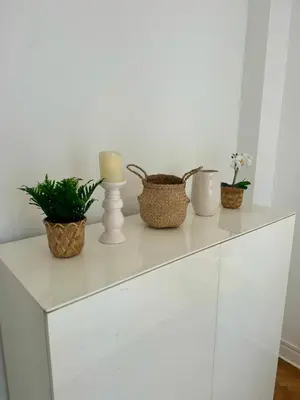 a white dresser with candles and plants on it at Cosy appartement gare du sud - Nice - 3 guests in Nice