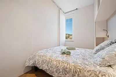 a bedroom with a bed and a window at La Fenêtre sur Mer - Superbe Vue Sur Le Port in Nice
