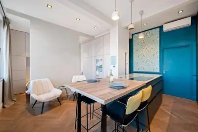 a kitchen with a large wooden table and chairs at La Fenêtre sur Mer - Superbe Vue Sur Le Port in Nice