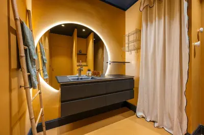 a bathroom with a sink and a mirror at La Fenêtre sur Mer - Superbe Vue Sur Le Port in Nice