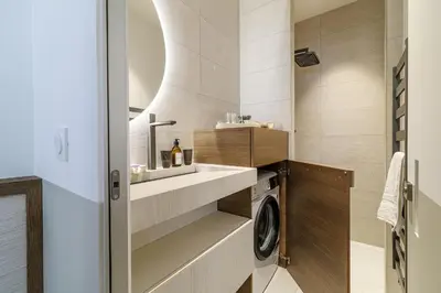 a bathroom with a sink and a washing machine at BERLIOZ - Splendid apartment in Nice city center in Nice