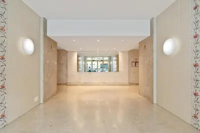 an empty hallway with white walls and a window at Suite de Dijon FSHH in Nice