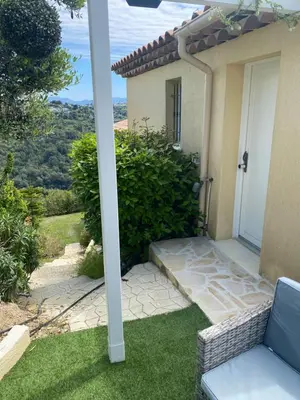 a porch of a house with a chair and a door at Chez Valentine in Nice