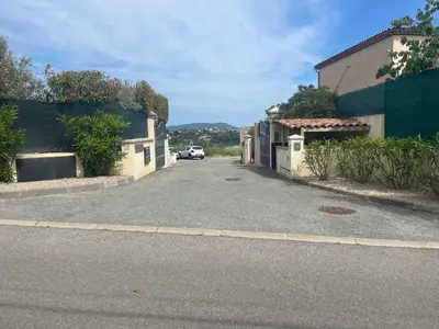 an empty street with a car driving down the street at Chez Valentine in Nice