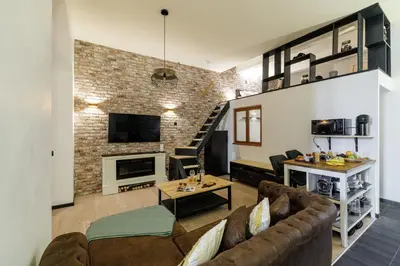 a living room with a couch and a fireplace at MY CASA - STALINGRAD 24 - Cosy loft - Port in Nice
