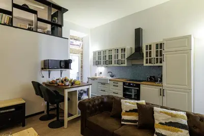 a living room with a couch and a kitchen at MY CASA - STALINGRAD 24 - Cosy loft - Port in Nice