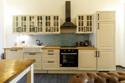 a kitchen with white cabinets and a sink at MY CASA - STALINGRAD 24 - Cosy loft - Port in Nice
