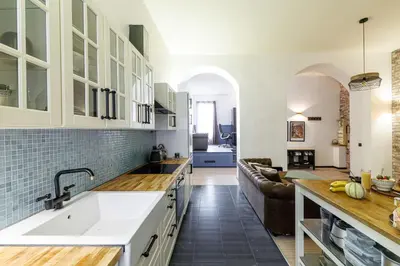 a kitchen with a sink and a living room at MY CASA - STALINGRAD 24 - Cosy loft - Port in Nice