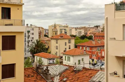 a view of a city with buildings and roofs at Studio climatisé au calme, terrasse vue colline in Nice