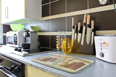 a kitchen with a counter top with a cutting board at Studio climatisé au calme, terrasse vue colline in Nice