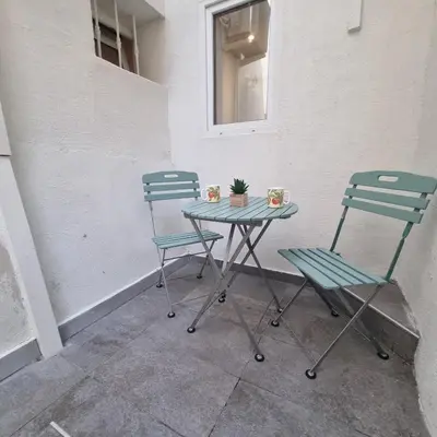 two chairs and a table with a plant on it at Spacious studio full of charm, recently updated in Nice