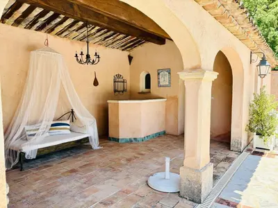 a patio with a hammock in a building at Hacienda Provençale- Piscine, Pétanque et Plenitude in Saint-Jeannet