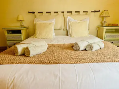 a large white bed with two towels on it at Hacienda Provençale- Piscine, Pétanque et Plenitude in Saint-Jeannet