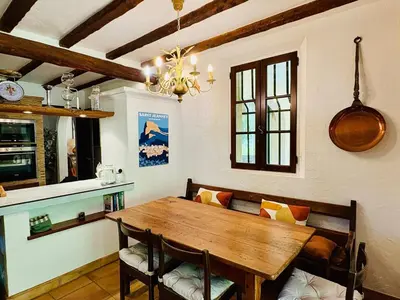 a dining room with a wooden table and chairs at Hacienda Provençale- Piscine, Pétanque et Plenitude in Saint-Jeannet