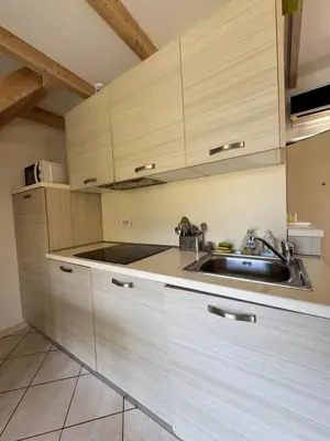 a kitchen with wooden cabinets and a sink at Apartment duplex in Eze sur Mer in Èze
