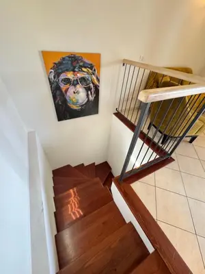 a staircase with a painting of a dog on the wall at Apartment duplex in Eze sur Mer in Èze