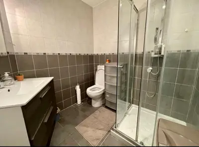 a bathroom with a toilet and a glass shower at 3p proche Port in Nice
