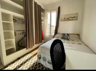 a small bedroom with a bed and a window at 3p proche Port in Nice