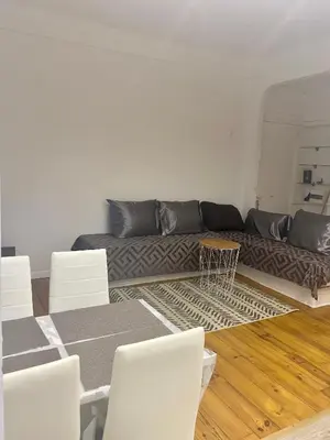 a living room with a couch and white chairs at 3p proche Port in Nice