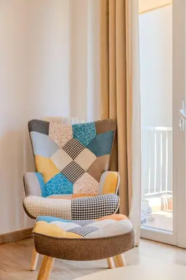 a chair with a quilt on it next to a window at Nice Appartement 4pers à 2 pas de la promenade in Nice