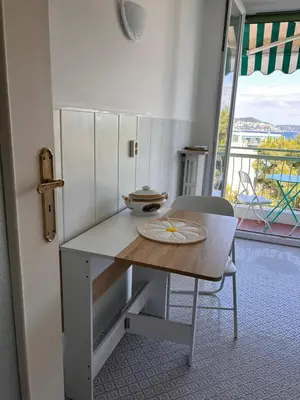 a kitchen with a counter and a table and a chair at Dolce Vita in Nice