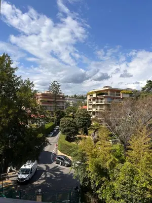 a city street with cars parked in a parking lot at Dolce Vita in Nice