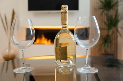 a bottle of wine sitting between two wine glasses at Ambiance cosy a la Niçoise in Nice