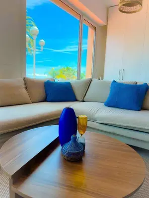 a living room with a couch and a table at Les pieds dans l eau in Nice