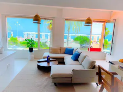 a living room with two couches and a table at Les pieds dans l eau in Nice