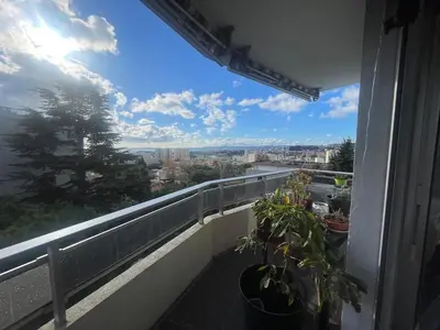 a balcony with plants and a view of the city at Large 2-room bright sea view near airport in Nice